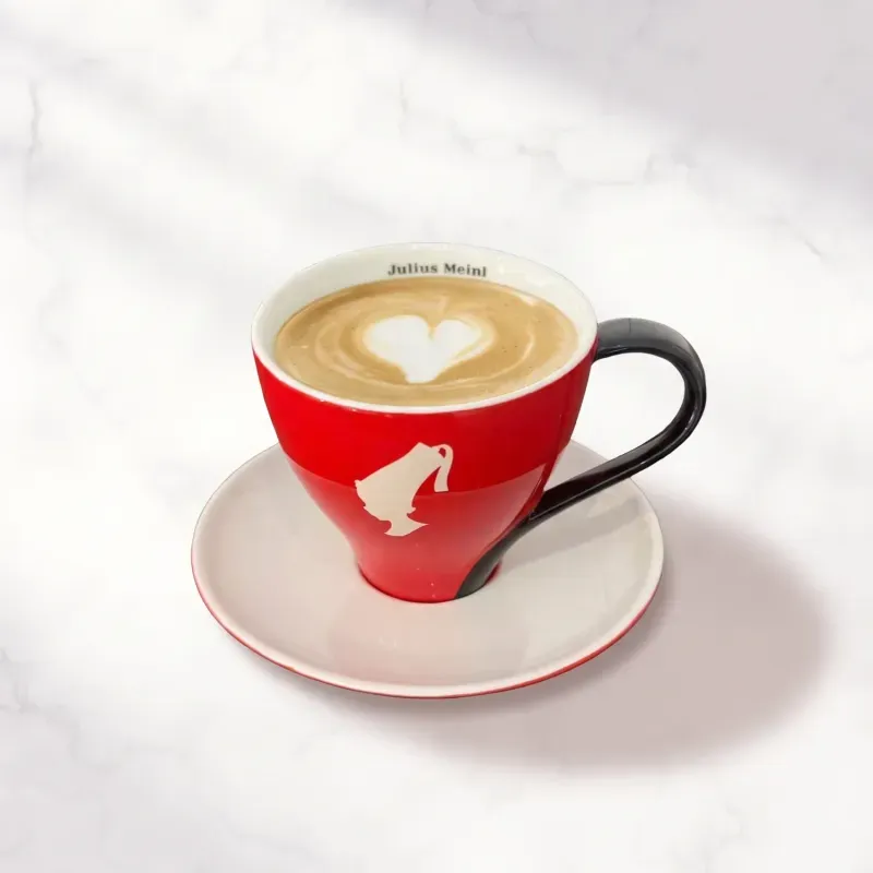 Flat white w czerwonej filiżance, z latte art w kształcie serca